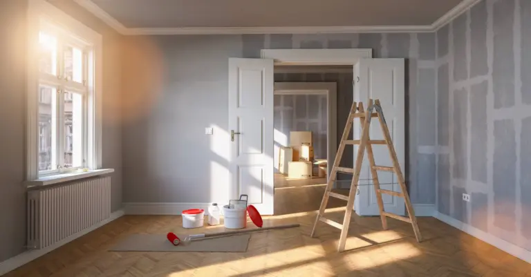 Room with taped drywall seams, a wooden stepladder, paint buckets and roller on herringbone wood floor, white double doors